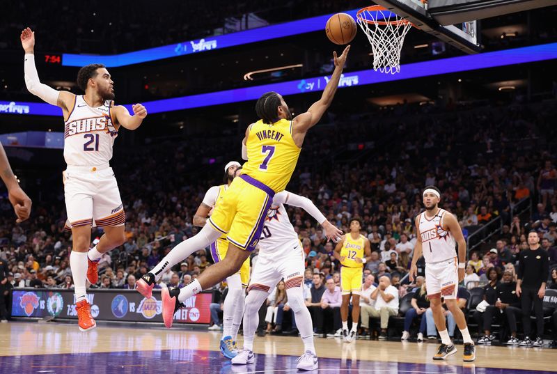 PHOENIX, ARIZONA - OCTOBER 17: Gabe Vincent #7 of the Los Angeles Lakers lays up a shot past Tyus Jones #21 of the Phoenix Suns during the first half of the preseason NBA game at Footprint Center on October 17, 2024 in Phoenix, Arizona. NOTE TO USER: User expressly acknowledges and agrees that, by downloading and/or using this photograph, user is consenting to the terms and conditions of the Getty Images License Agreement.  (Photo by Christian Petersen/Getty Images)