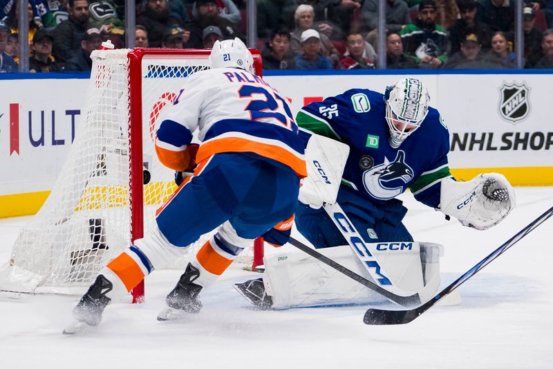 Nov 15, 2023; Vancouver, British Columbia, CAN; Vancouver Canucks goalie Thatcher Demko (35) makes a save on New York Islanders forward Kyle Palmieri (21) in the second period at Rogers Arena. Mandatory Credit: Bob Frid-USA TODAY Sports