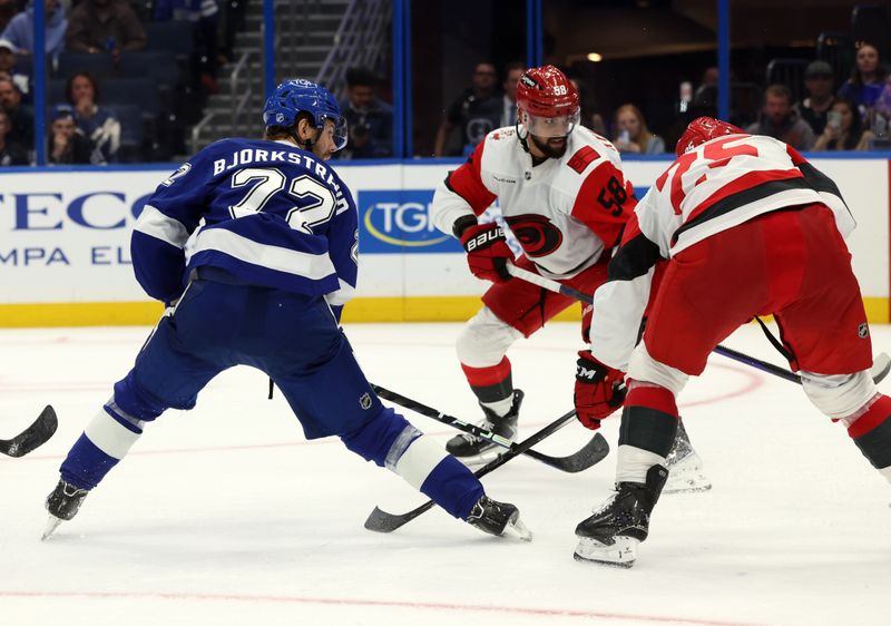 Sep 26, 2025; Tampa, Florida, USA; Tampa Bay Lightning right wing Oliver Bjorkstrand (22) scores a goal against the Carolina Hurricanes during the third period at Benchmark International Arena. Mandatory Credit: Kim Klement Neitzel-Imagn Images