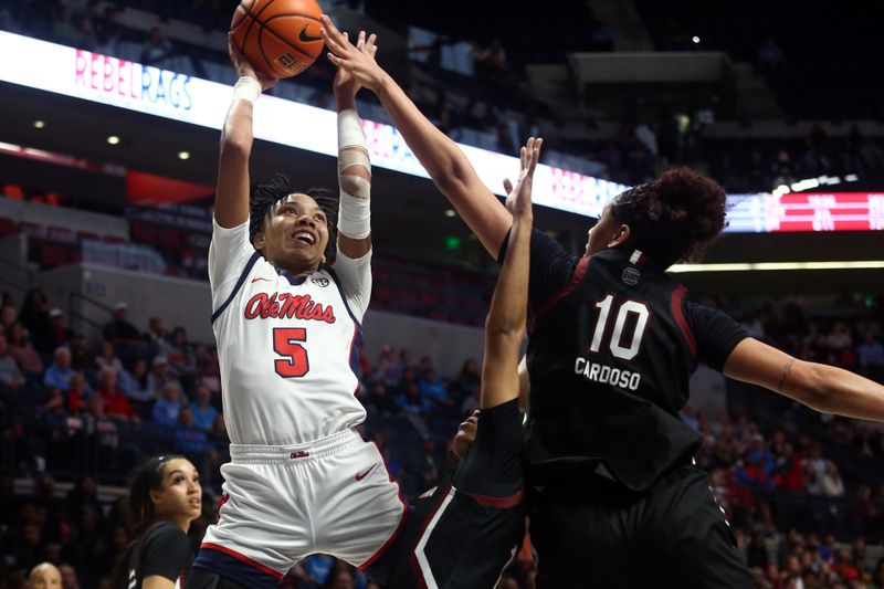 Feb 19, 2023; Oxford, Mississippi, USA; Mississippi Rebels forward Snudda Collins (5) shoots as South Carolina Gamecocks center Kamilla Cardoso (10) defends during the second half at The Sandy and John Black Pavilion at Ole Miss. Mandatory Credit: Petre Thomas-USA TODAY Sports