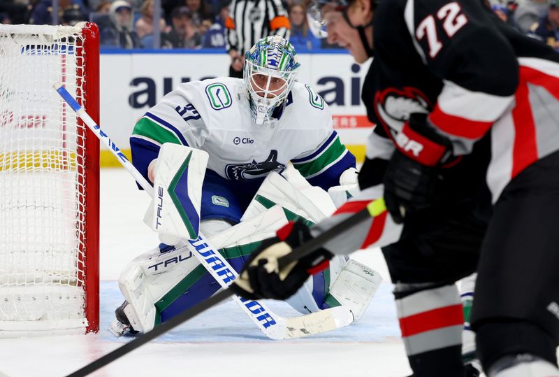 Nov 29, 2024; Buffalo, New York, USA;  Vancouver Canucks goaltender Kevin Lankinen (32) looks for the puck during the second period against the Buffalo Sabres at KeyBank Center. Mandatory Credit: Timothy T. Ludwig-Imagn Images