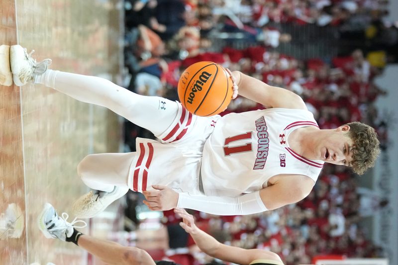 Feb 4, 2024; Madison, Wisconsin, USA; Wisconsin Badgers guard Max Klesmit (11) dribbles the ball during the second half against the Purdue Boilermakers at the Kohl Center. Mandatory Credit: Kayla Wolf-USA TODAY Sports