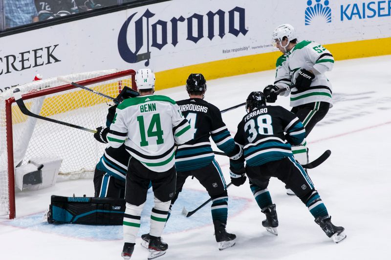 Mar 5, 2024; San Jose, California, USA; Dallas Stars center Wyatt Johnston (53) scores as San Jose Sharks defenseman Kyle Burroughs (4) and defenseman Mario Ferraro (38) defend during the third period at SAP Center at San Jose. Mandatory Credit: John Hefti-USA TODAY Sports