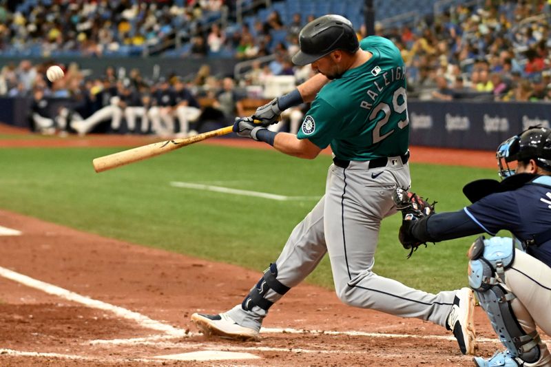 Jun 26, 2024; St. Petersburg, Florida, USA; Seattle Mariners designated hitter Cal Raleigh (29) hits a three run home run against the Tampa Bay Rays in the sixth inning at Tropicana Field. Mandatory Credit: Jonathan Dyer-USA TODAY Sports