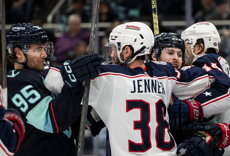 Jan 28, 2024; Seattle, Washington, USA; Seattle Kraken forward Andre Burakovsky (95) and forward Yanni Gourde (37), second from right, scuffle with Columbus Blue Jackets forward Boone Jenner (38) and defenseman Erik Gudbranson (44) during the second period at Climate Pledge Arena. Mandatory Credit: Stephen Brashear-USA TODAY Sports