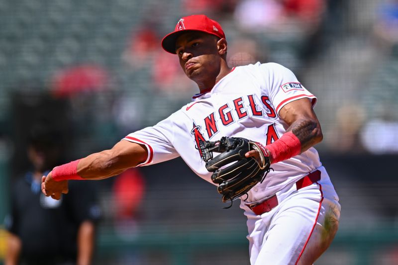 Aug 24, 2025; Anaheim, California, USA; Los Angeles Angels second baseman Christian Moore (4) throws to first base against the Chicago Cubs during the fifth inning at Angel Stadium. Mandatory Credit: Jonathan Hui-Imagn Images
