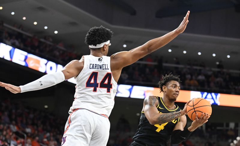 Feb 14, 2023; Auburn, Alabama, USA;  Auburn Tigers center Dylan Cardwell (44) defends a shot by Missouri Tigers guard DeAndre Gholston (4) during the first half at Neville Arena. Mandatory Credit: Julie Bennett-USA TODAY Sports