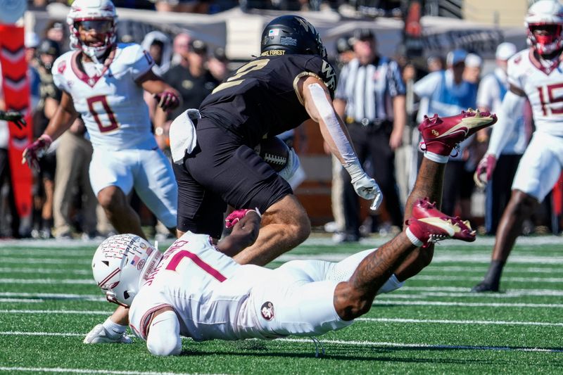 Oct 28, 2023; Winston-Salem, North Carolina, USA; Wake Forest Demon Deacons wide receiver Taylor Morin (2) evades Florida State Seminoles defensive back Jarrian Jones (7) during the first half at Allegacy Federal Credit Union Stadium. Mandatory Credit: Jim Dedmon-USA TODAY Sports