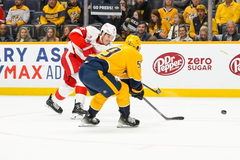 Oct 19, 2024; Nashville, Tennessee, USA; Detroit Red Wings defenseman Ben Chiarot (8) takes a shot on goal as Nashville Predators defenseman Roman Josi (59) defends during the second period at Bridgestone Arena. Mandatory Credit: Steve Roberts-Imagn Images