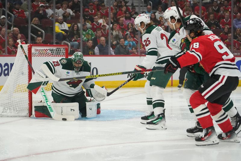 Oct 4, 2024; Chicago, Illinois, USA; Minnesota Wild goaltender Marc-Andre Fleury (29) makes a save on Chicago Blackhawks center Connor Bedard (98) during the first period at United Center. Mandatory Credit: David Banks-Imagn Images