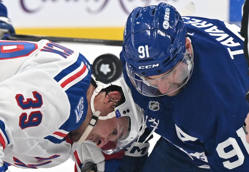 Oct 16, 2025; Toronto, Ontario, CAN;  New York Rangers forward Sam Carrick (39) and Toronto Maple Leafs forward John Tavares (91) battle for the puck on a faceoff in the third period at Scotiabank Arena. Mandatory Credit: Dan Hamilton-Imagn Images