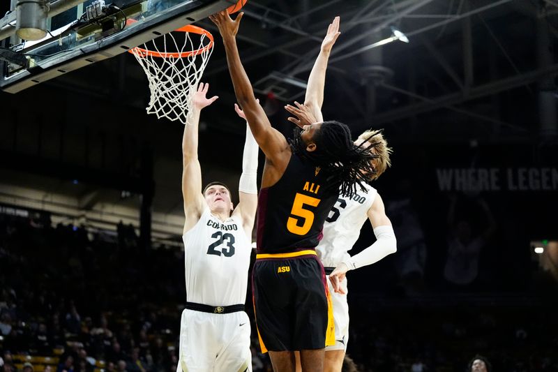 Jan 28, 2025; Boulder, Colorado, USA; Arizona State Sun Devils guard Amier Ali (5) shoots the ball against Colorado Buffaloes forward Andrej Jakimovski (23) and forward Trevor Baskin (6) in the first half at CU Events Center. Mandatory Credit: Ron Chenoy-Imagn Images