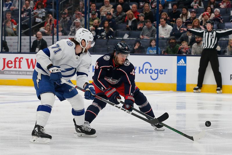 Feb 10, 2024; Columbus, Ohio, USA; Columbus Blue Jackets Forward Cole Sillinger (4) flips the puck away from Tampa Bay Lightning center Anthony Cirelli (71) during the first period at Nationwide Arena. Mandatory Credit: Russell LaBounty-USA TODAY Sports