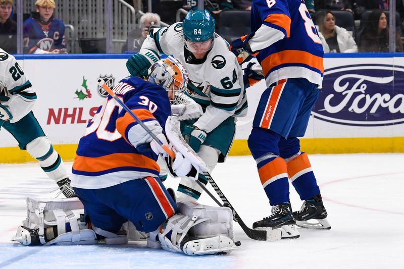 Dec 5, 2023; Elmont, New York, USA; New York Islanders goaltender Ilya Sorokin (30) makes a save on San Jose Sharks right wing Mitchell Russell (64) during the third period at UBS Arena. Mandatory Credit: Dennis Schneidler-USA TODAY Sports