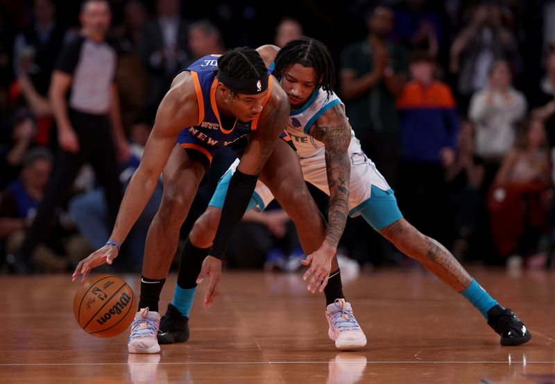 NEW YORK, NEW YORK - NOVEMBER 28:  Miles McBride #2 of the New York Knicks runs out the clock as Nick Smith Jr. #8 of the Charlotte Hornets defends during the second half of an NBA In-Season Tournament game at Madison Square Garden on November 28, 2023 in New York City. The New York Knicks defeated the Charlotte Hornets 115-91.NOTE TO USER: User expressly acknowledges and agrees that, by downloading and or using this photograph, User is consenting to the terms and conditions of the Getty Images License Agreement. (Photo by Elsa/Getty Images)