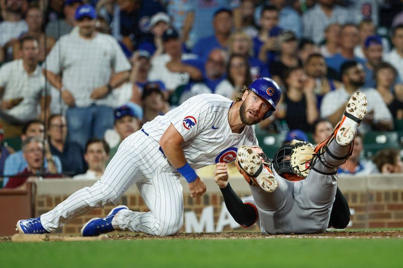 Jun 17, 2024; Chicago, Illinois, USA; Chicago Cubs first baseman Patrick Wisdom (16) reacts after being tagged out at home plate by San Francisco Giants catcher Patrick Bailey (14) during the fifth inning at Wrigley Field. Mandatory Credit: Kamil Krzaczynski-USA TODAY Sports