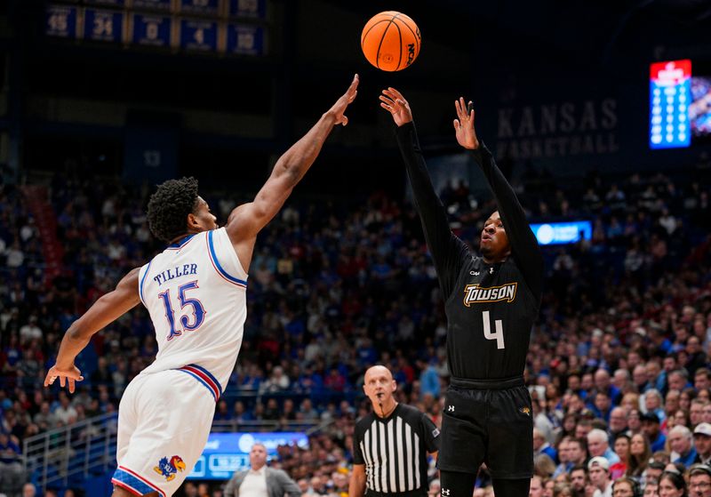 Dec 16, 2025; Lawrence, Kansas, USA; Towson Tigers guard Dylan Williamson (4) shoots against Kansas Jayhawks forward Bryson Tiller (15) during the first half at Allen Fieldhouse. Mandatory Credit: Jay Biggerstaff-Imagn Images