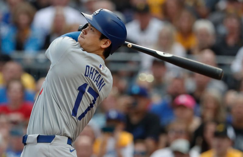 Jun 5, 2024; Pittsburgh, Pennsylvania, USA;  Los Angeles Dodgers designated hitter Shohei Ohtani (17) hits a two run home run against the Pittsburgh Pirates during the third inning at PNC Park. Mandatory Credit: Charles LeClaire-USA TODAY Sports