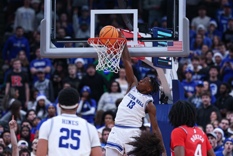 Dec 13, 2025; Newark, New Jersey, USA; Seton Hall Pirates guard Trey Parker (13) dunks the ball during the first half against the Rutgers Scarlet Knights at Prudential Center. Mandatory Credit: Vincent Carchietta-Imagn Images