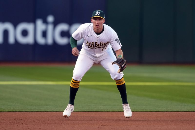 May 3, 2024; Oakland, California, USA; Oakland Athletics third baseman Brett Harris (77) defends against the Miami Marlins during the first inning at Oakland-Alameda County Coliseum. Mandatory Credit: Darren Yamashita-USA TODAY Sports