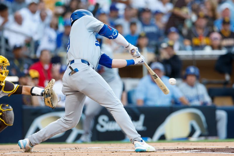 Jul 30, 2024; San Diego, California, USA;  Los Angeles Dodgers second baseman Gavin Lux (9) hits a sacrifice fly during the first inning against the San Diego Padres at Petco Park. Mandatory Credit: David Frerker-USA TODAY Sports