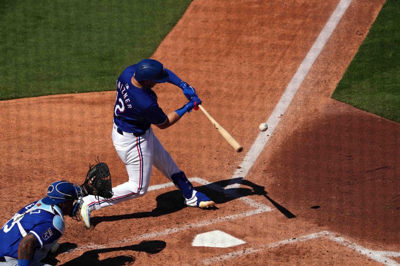 Mar 8, 2024; Surprise, Arizona, USA; Texas Rangers catcher Andrew Knizner (12) bats against the Kansas City Royals during the third inning at Surprise Stadium. Mandatory Credit: Joe Camporeale-USA TODAY Sports