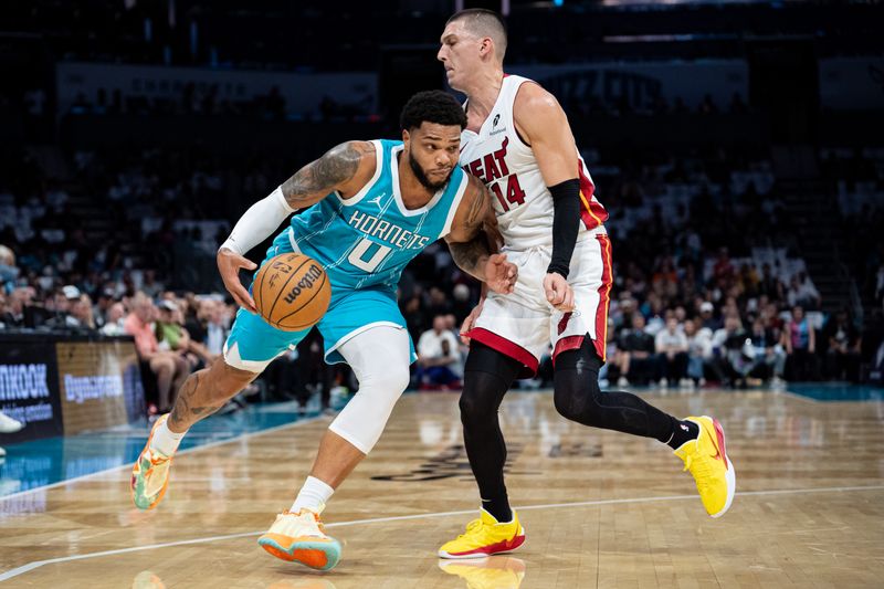 CHARLOTTE, NORTH CAROLINA - OCTOBER 26: Tyler Herro #14 of the Miami Heat guards Miles Bridges #0 of the Charlotte Hornets in the first quarter during their game at Spectrum Center on October 26, 2024 in Charlotte, North Carolina. NOTE TO USER: User expressly acknowledges and agrees that, by downloading and or using this photograph, User is consenting to the terms and conditions of the Getty Images License Agreement. (Photo by Jacob Kupferman/Getty Images)