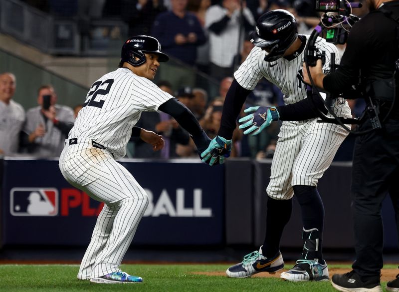 Oct 30, 2024; New York, New York, USA; New York Yankees outfielder Aaron Judge (99) celebrates with outfielder Juan Soto (22) after hitting a two-run during the first inning against the Los Angeles Dodgers in game five of the 2024 MLB World Series at Yankee Stadium. Mandatory Credit: Vincent Carchietta-Imagn Images