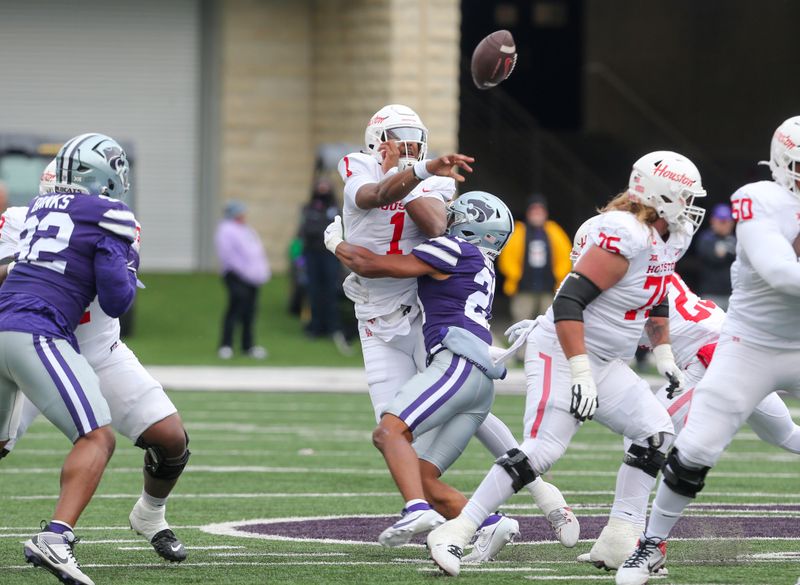 Oct 28, 2023; Manhattan, Kansas, USA; Houston Cougars quarterback Donovan Smith (1) is hit by Kansas State Wildcats safety Marques Sigle (21) during the first quarter at Bill Snyder Family Football Stadium. Mandatory Credit: Scott Sewell-USA TODAY Sports