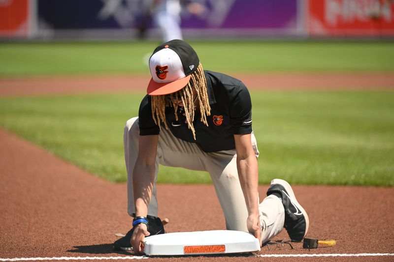 Apr 28, 2024; Baltimore, Maryland, USA;  A grounds crew member places third base on the field prior to the game between the Baltimore Orioles and the Oakland Athletics at Oriole Park at Camden Yards. Mandatory Credit: James A. Pittman-USA TODAY Sports