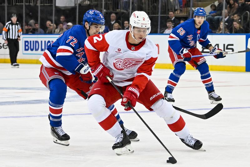 Oct 14, 2024; New York, New York, USA;  Detroit Red Wings defenseman Olli Maatta (2) skates with the puck while chased by New York Rangers center Filip Chytil (72) during the third period at Madison Square Garden. Mandatory Credit: Dennis Schneidler-Imagn Images