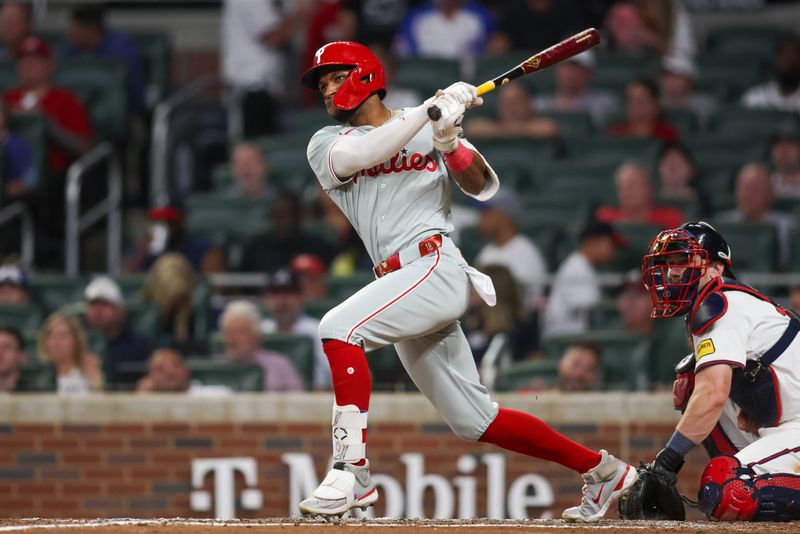 Aug 21, 2024; Atlanta, Georgia, USA; Philadelphia Phillies center fielder Johan Rojas (18) hits a double against the Atlanta Braves in the sixth inning at Truist Park. Mandatory Credit: Brett Davis-USA TODAY Sports