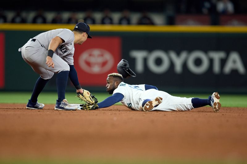 May 14, 2025; Seattle, Washington, USA; Seattle Mariners left fielder Randy Arozarena (56) against New York Yankees shortstop Anthony Volpe (11) during the fourth inning at T-Mobile Park. Mandatory Credit: John Froschauer-Imagn Images
