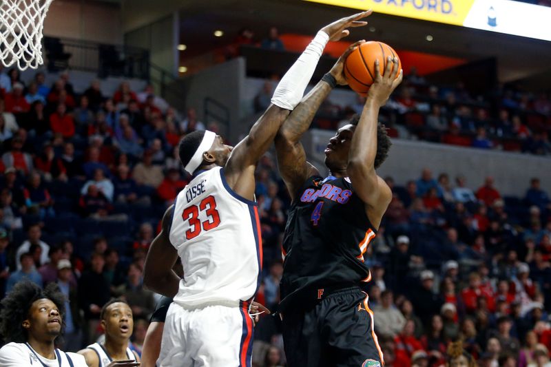 Jan 10, 2024; Oxford, Mississippi, USA; Florida Gators forward Tyrese Samuel (4) shoots as Mississippi Rebels forward Moussa Cisse (33) defends during the first half at The Sandy and John Black Pavilion at Ole Miss. Mandatory Credit: Petre Thomas-USA TODAY Sports