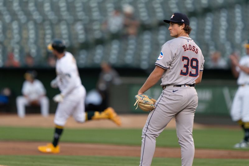 Jul 23, 2024; Oakland, California, USA;  Houston Astros pitcher Jake Bloss (39) reacts as Oakland Athletics outfielder Seth Brown (15) runs the bases after hitting a solo home run during the fourth inning at Oakland-Alameda County Coliseum. Mandatory Credit: Stan Szeto-USA TODAY Sports