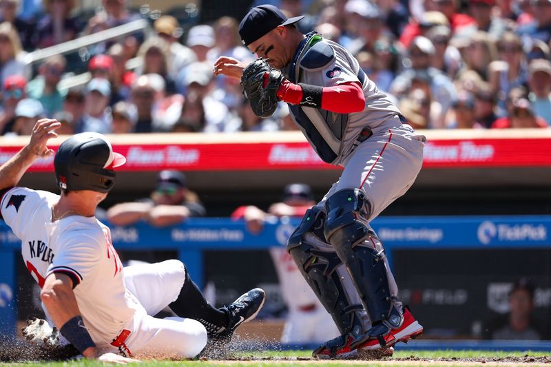 May 5, 2024; Minneapolis, Minnesota, USA; Boston Red Sox catcher Reese McGuire (3) fields the ball at home plate for a force out against Max Kepler (26) during the second inning at Target Field. Mandatory Credit: Matt Krohn-USA TODAY Sports