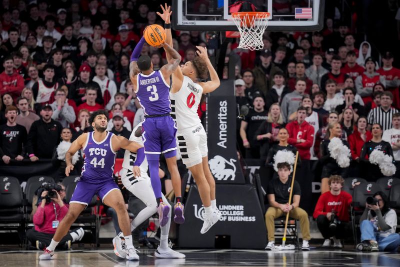 Jan 16, 2024; Cincinnati, Ohio, USA;  Cincinnati Bearcats guard Dan Skillings Jr. (0) blocks the shot by TCU Horned Frogs guard Avery Anderson III (3) in the first half at Fifth Third Arena. Mandatory Credit: Aaron Doster-USA TODAY Sports