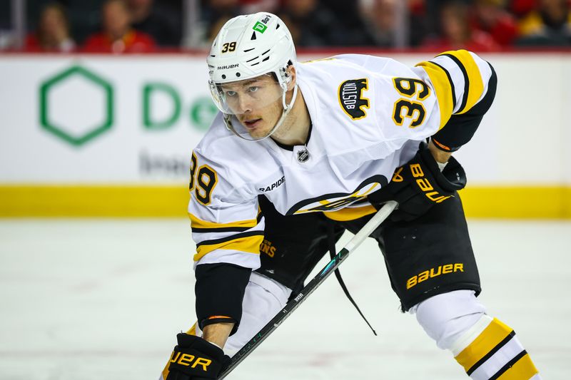 Dec 29, 2025; Calgary, Alberta, CAN; Boston Bruins center Morgan Geekie (39) during the face off against the Calgary Flames during the third period at Scotiabank Saddledome. Mandatory Credit: Sergei Belski-Imagn Images