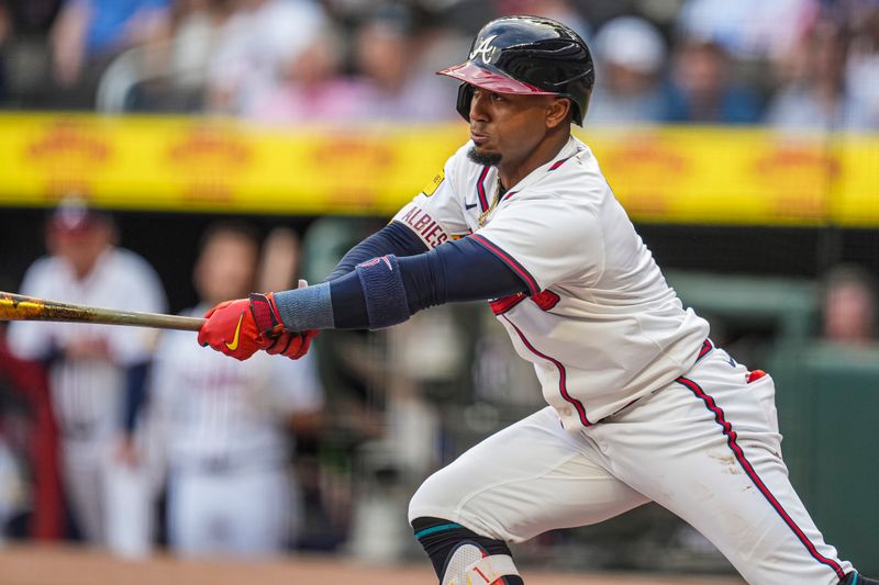 May 14, 2024; Cumberland, Georgia, USA; Atlanta Braves second baseman Ozzie Albies (1) gets a single against the Chicago Cubs during the first inning at Truist Park. Mandatory Credit: Dale Zanine-USA TODAY Sports