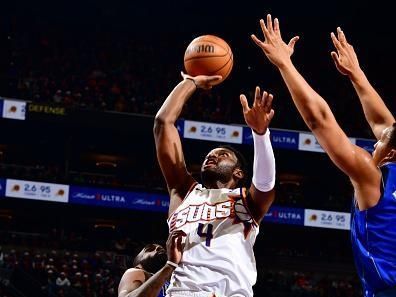 PHOENIX, AZ - DECEMBER 25: Chimezie Metu #4 of the Phoenix Suns shoots the ball during the game against the Dallas Mavericks on December 25, 2023 at Footprint Center in Phoenix, Arizona. NOTE TO USER: User expressly acknowledges and agrees that, by downloading and or using this photograph, user is consenting to the terms and conditions of the Getty Images License Agreement. Mandatory Copyright Notice: Copyright 2023 NBAE (Photo by Barry Gossage/NBAE via Getty Images)