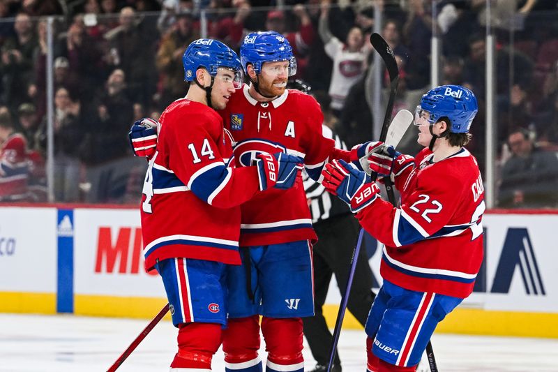 Dec 2, 2023; Montreal, Quebec, CAN; Montreal Canadiens center Nick Suzuki (14) celebrates his goal against the Detroit Red Wings with defenseman Mike Matheson (8) and right wing Cole Caufield (22) during the third period at Bell Centre. Mandatory Credit: David Kirouac-USA TODAY Sports