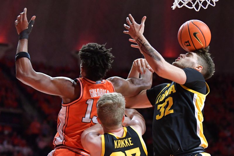 Feb 24, 2024; Champaign, Illinois, USA;  The ball bounces off the head of Iowa Hawkeyes forward Owen Freeman (32) as he tries to control a loose ball against Illinois Fighting Illini forward Quincy Guerrier (13) during the first half at State Farm Center. Mandatory Credit: Ron Johnson-USA TODAY Sports