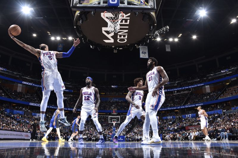 ORLANDO, FL - JANUARY 19: Marcus Morris Sr. #5 of the Philadelphia 76ers grabs the rebound during the game against the Orlando Magic on January 19, 2024 at the Kia Center in Orlando, Florida. NOTE TO USER: User expressly acknowledges and agrees that, by downloading and or using this photograph, User is consenting to the terms and conditions of the Getty Images License Agreement. Mandatory Copyright Notice: Copyright 2024 NBAE (Photo by Fernando Medina/NBAE via Getty Images)