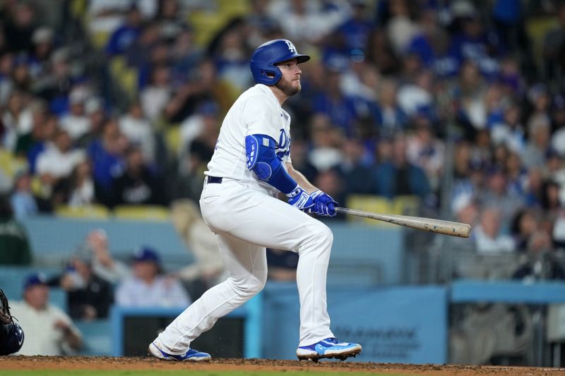 Sep 20, 2023; Los Angeles, California, USA; Los Angeles Dodgers third baseman Max Muncy (13) hits a home run in the sixth inning against the Detroit Tigers at Dodger Stadium. Mandatory Credit: Kirby Lee-USA TODAY Sports