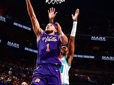 PHOENIX, AZ - DECEMBER 29: Devin Booker #1 of the Phoenix Suns drives to the basket during the game against the Charlotte Hornets on December 29 2023 at Footprint Center in Phoenix, Arizona. NOTE TO USER: User expressly acknowledges and agrees that, by downloading and or using this photograph, user is consenting to the terms and conditions of the Getty Images License Agreement. Mandatory Copyright Notice: Copyright 2023 NBAE (Photo by Barry Gossage/NBAE via Getty Images)