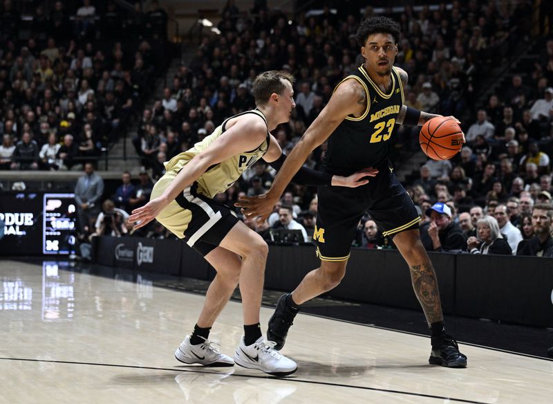 Feb 17, 2026; West Lafayette, Indiana, USA; Michigan Wolverines forward Yaxel Lendeborg (23) drives the ball against Purdue Boilermakers guard Fletcher Loyer (2) during the first half at Mackey Arena. Mandatory Credit: Marc Lebryk-Imagn Images