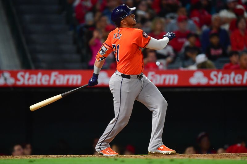 Jun 7, 2024; Anaheim, California, USA; Houston Astros designated hitter Yainer Diaz (21) hits a two run home run against the Los Angeles Angels during the seventh inning at Angel Stadium. Mandatory Credit: Gary A. Vasquez-USA TODAY Sports