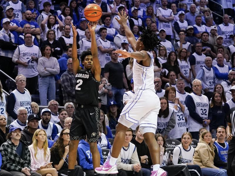 Feb 14, 2026; Provo, Utah, USA; Isaiah Johnson (2) of the Colorado Buffaloes takes a three-point shot guarded by BYU Cougars guard Robert Wright III (1) during overtime at the Marriott Center. Mandatory Credit: Aaron Baker-Imagn Images