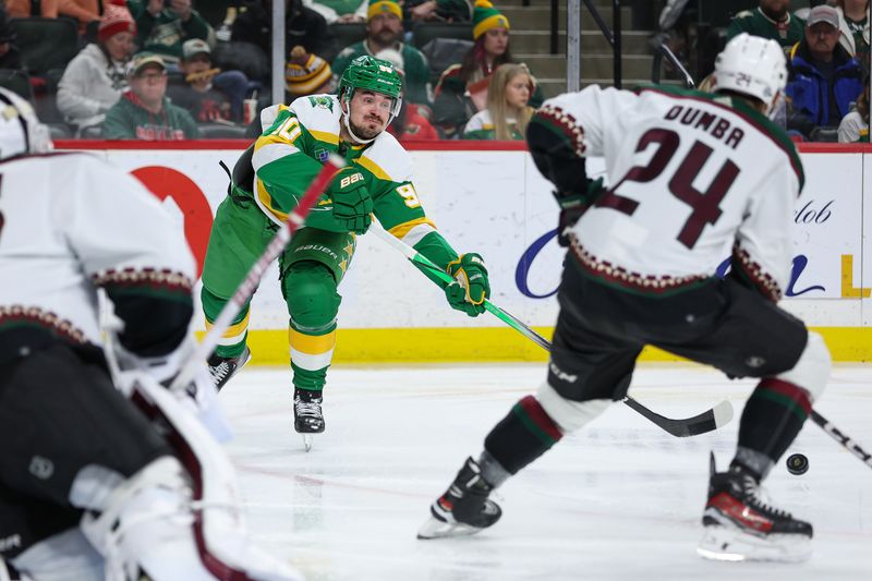 Jan 13, 2024; Saint Paul, Minnesota, USA; Minnesota Wild left wing Marcus Johansson (90) passes as Arizona Coyotes defenseman Matt Dumba (24) defends during the second period at Xcel Energy Center. Mandatory Credit: Matt Krohn-USA TODAY Sports