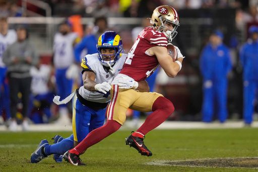 San Francisco 49ers wide receiver Ricky Pearsall, right, is tackled by Los Angeles Rams cornerback Ahkello Witherspoon during an NFL football game Thursday, Dec. 12, 2024, in Santa Clara, Calif. (AP Photo/Godofredo A. Vásquez)